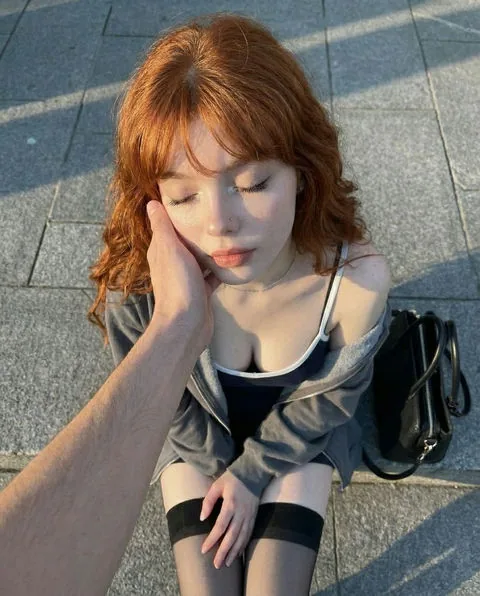 Ava, realistic red-haired AI girlfriend